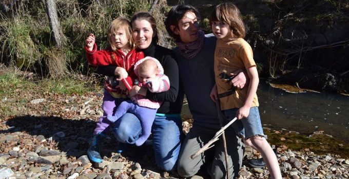 group photo of a family beside a creek