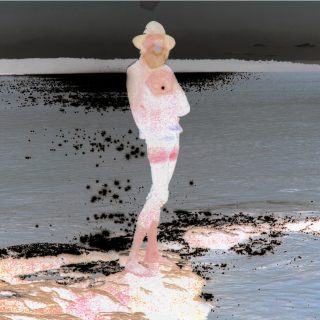 album cover showing an inverted colour scene of a thin man in a hat on the edge of a body of water