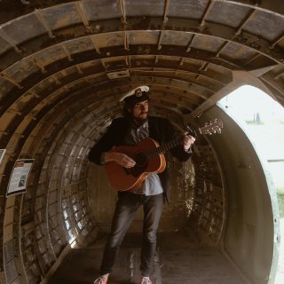 me playing guitar in a C-47